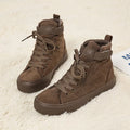 Women's high-top canvas shoes with velcro strap, black colour, rubber sole on a plain background