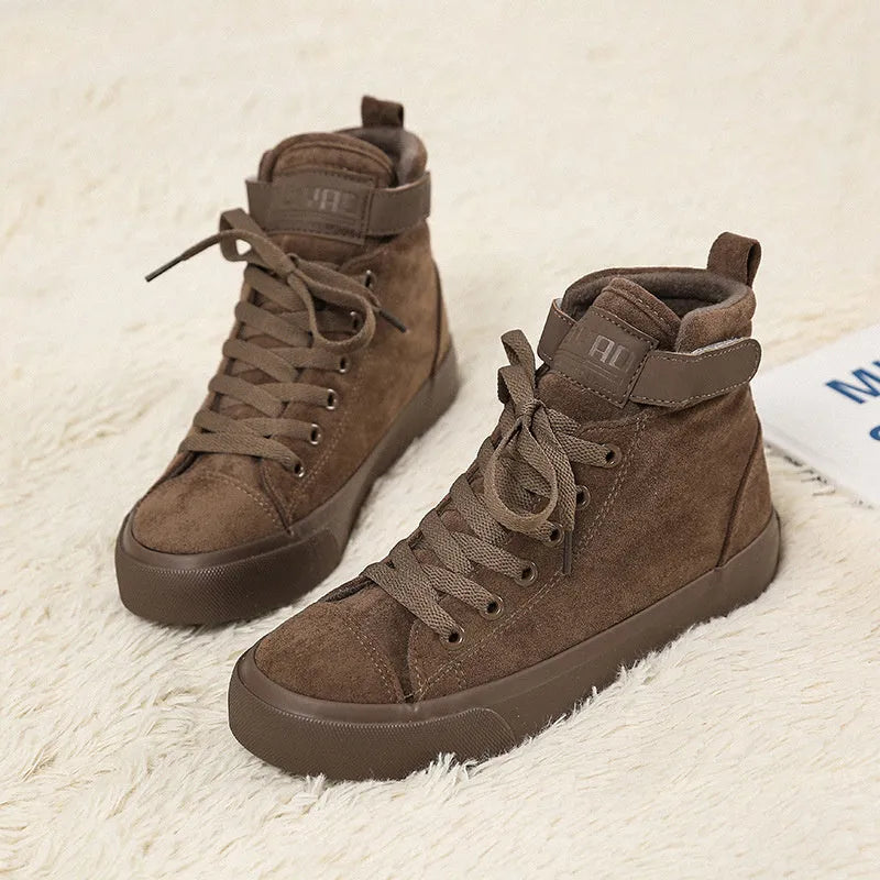 Women's high-top canvas shoes with velcro strap, black colour, rubber sole on a plain background