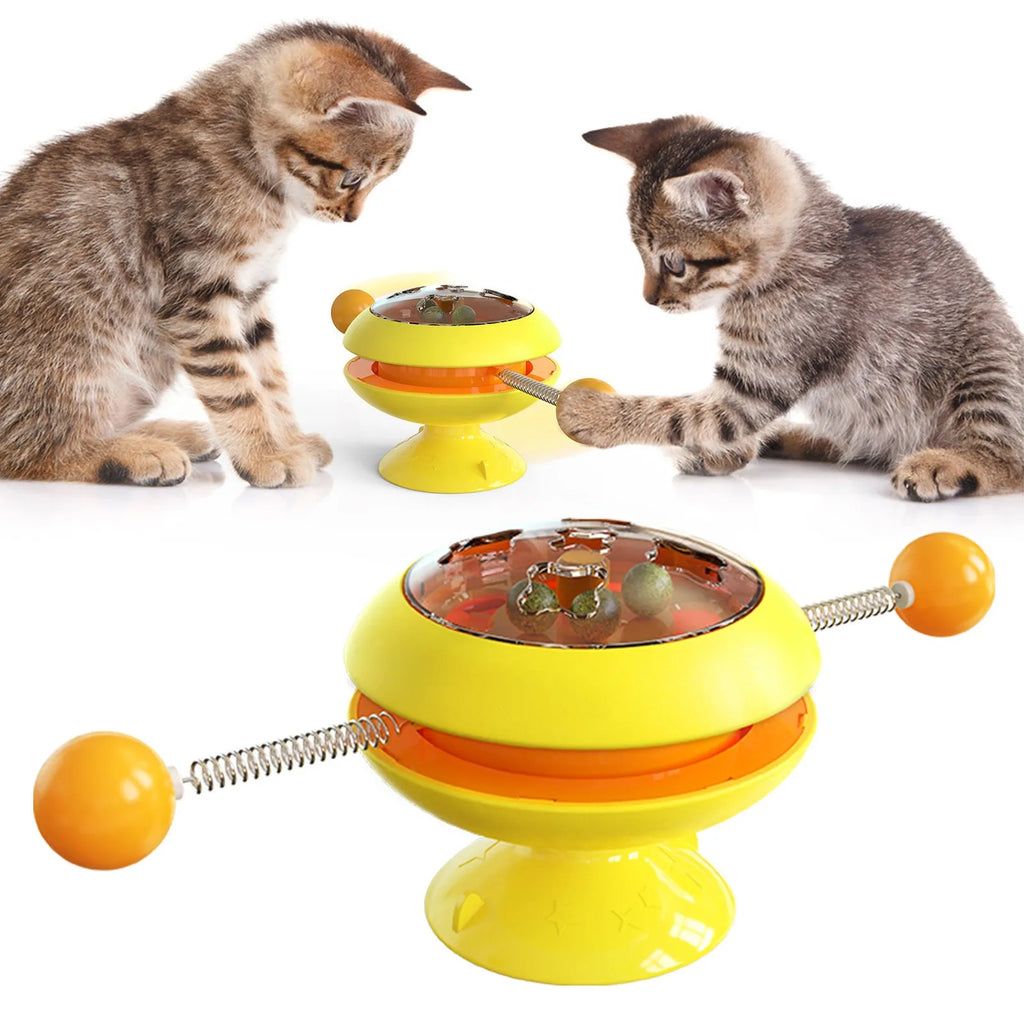 Rotating turntable cat toy with transparent section showing catnip balls and large suction cup base