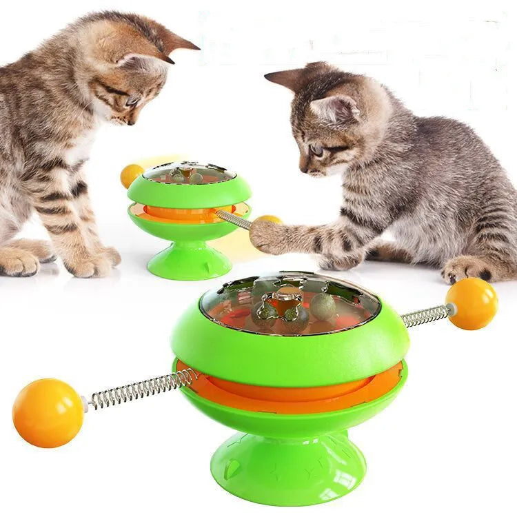 Rotating turntable cat toy with transparent section showing catnip balls and large suction cup base