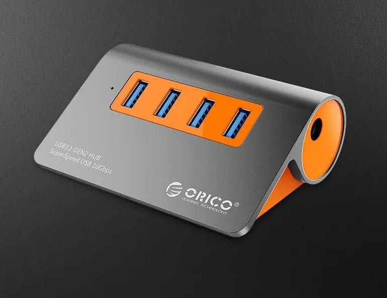 Dark grey and orange aluminium USB C hub with four USB 3.1 ports and a separate cable.