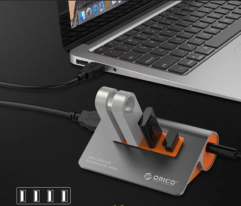 Dark grey and orange aluminium USB C hub with four USB 3.1 ports and a separate cable.