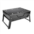Folding portable charcoal barbecue grill on outdoor table showing 35x27x20cm cooking area