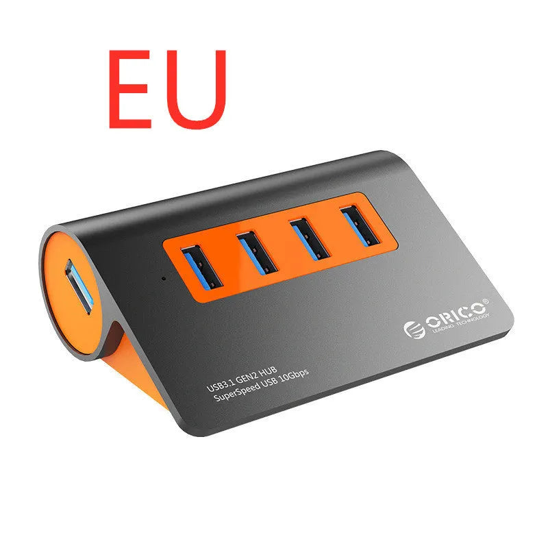 Dark grey and orange aluminium USB C hub with four USB 3.1 ports and a separate cable.