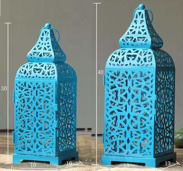 Blue geometric metal Moroccan hanging candlestick with hollow design for candle display.