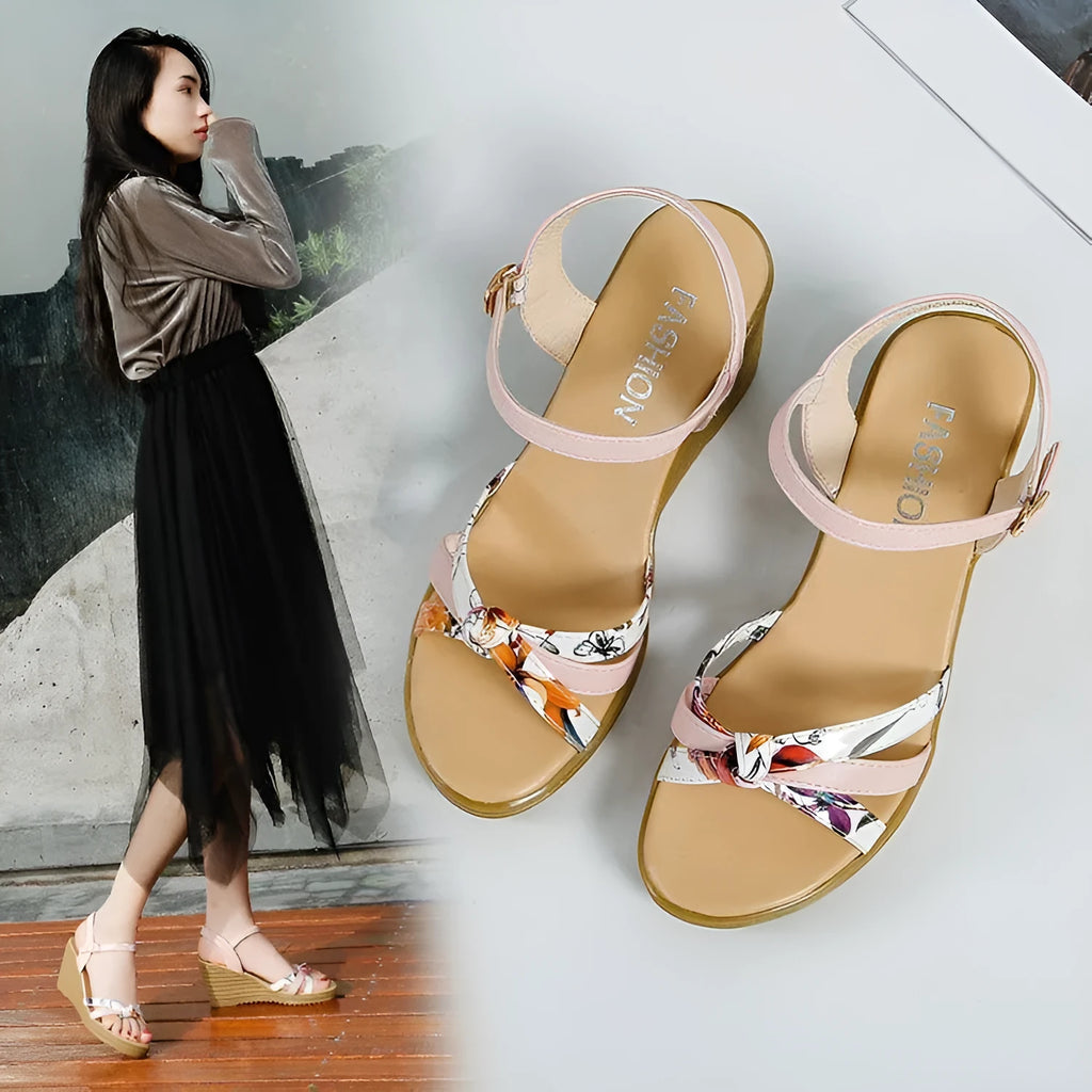 Women's pink wedge heel sandals with fish mouth design and a single ankle buckle.