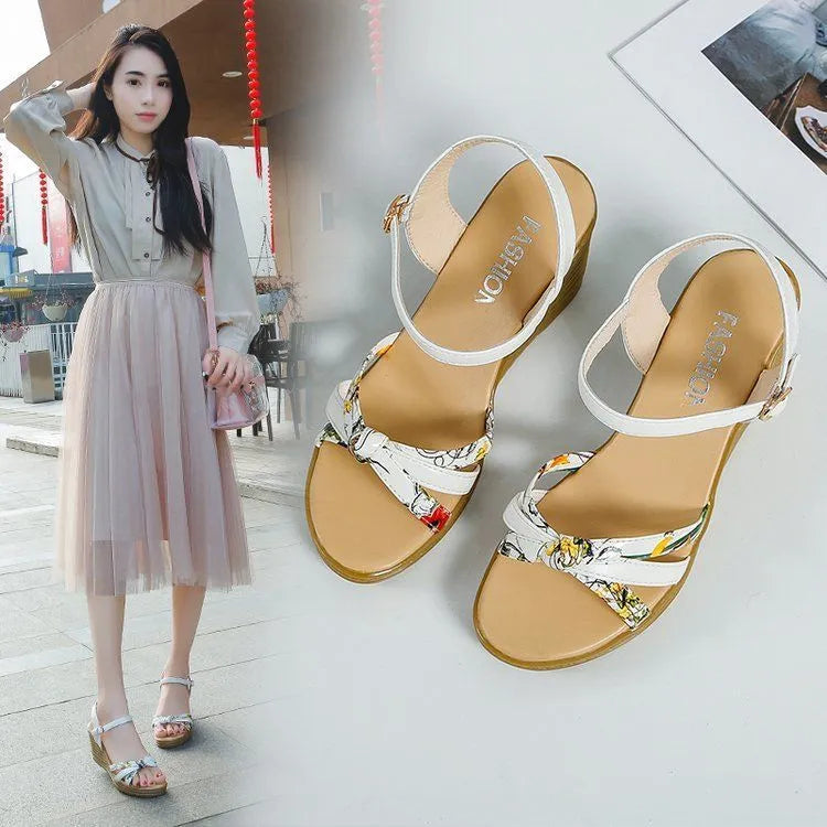 Women's pink wedge heel sandals with fish mouth design and a single ankle buckle.