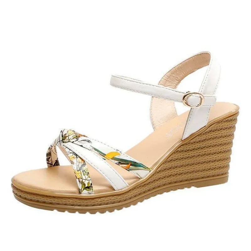 Women's pink wedge heel sandals with fish mouth design and a single ankle buckle.