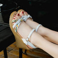 Women's pink wedge heel sandals with fish mouth design and a single ankle buckle.