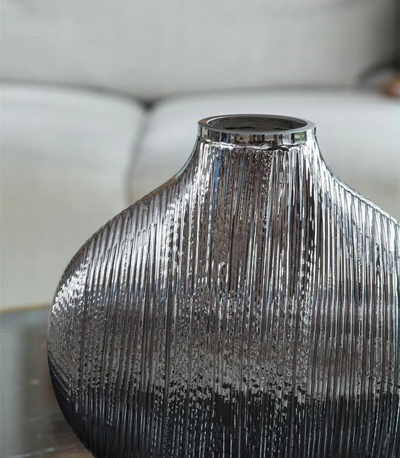 Silver brushed electroplated glass vase L size 25x13x25cm with striped finish on table