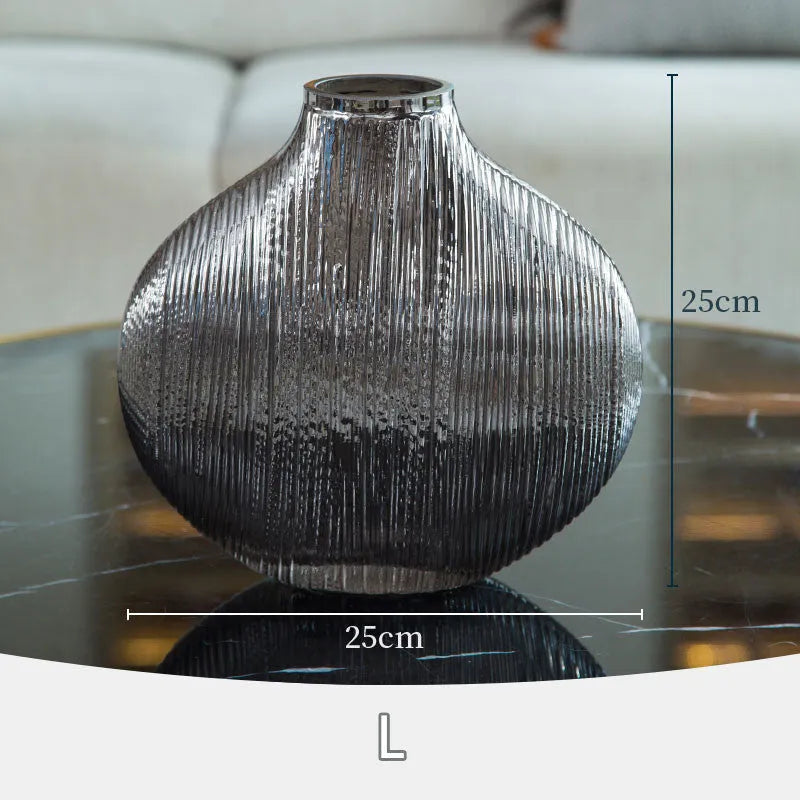 Silver brushed electroplated glass vase L size 25x13x25cm with striped finish on table