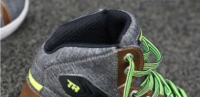 Black and grey men's casual motorcycle short boots with breathable panels and a non-slip sole.