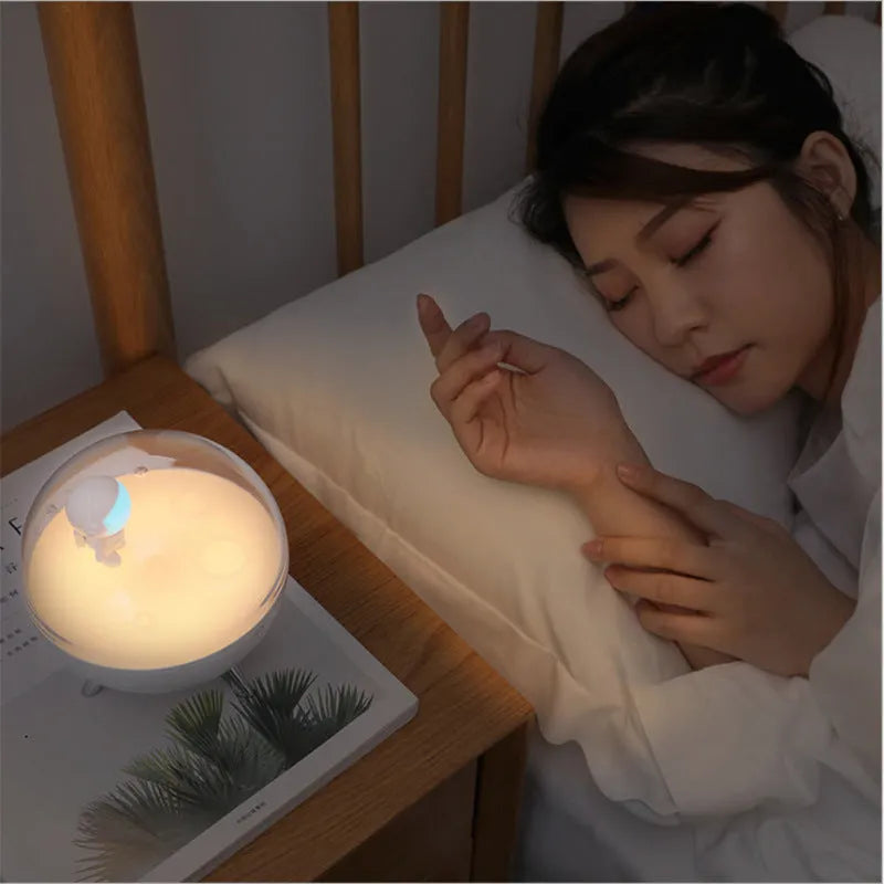 Modern USB LED night light with plastic shade in white and blue colour options on a desk.