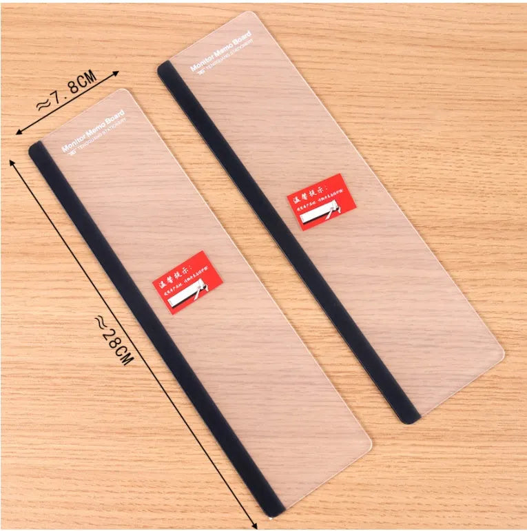 Transparent acrylic computer monitor side pane 28 x 7.8 cm holding a note on the side of a monitor