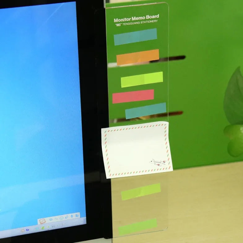 Transparent acrylic computer monitor side pane 28 x 7.8 cm holding a note on the side of a monitor