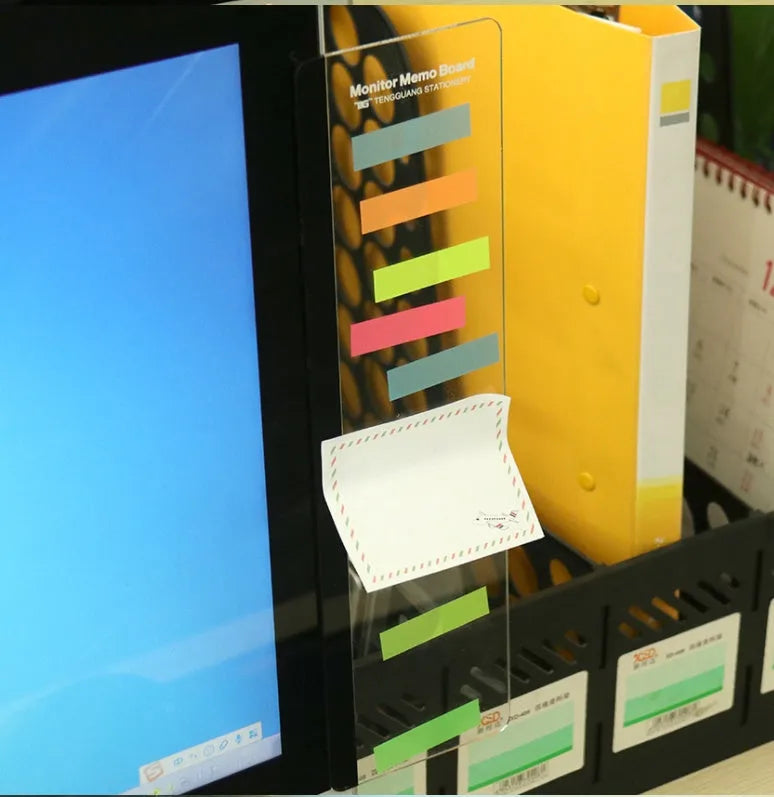 Transparent acrylic computer monitor side pane 28 x 7.8 cm holding a note on the side of a monitor