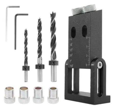 Black aluminium alloy woodworking perforation locator tool with drill bits and sleeves for dowel joinery.