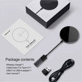 Black MagSlim magnetic wireless charging pad on a table next to a mobile phone.