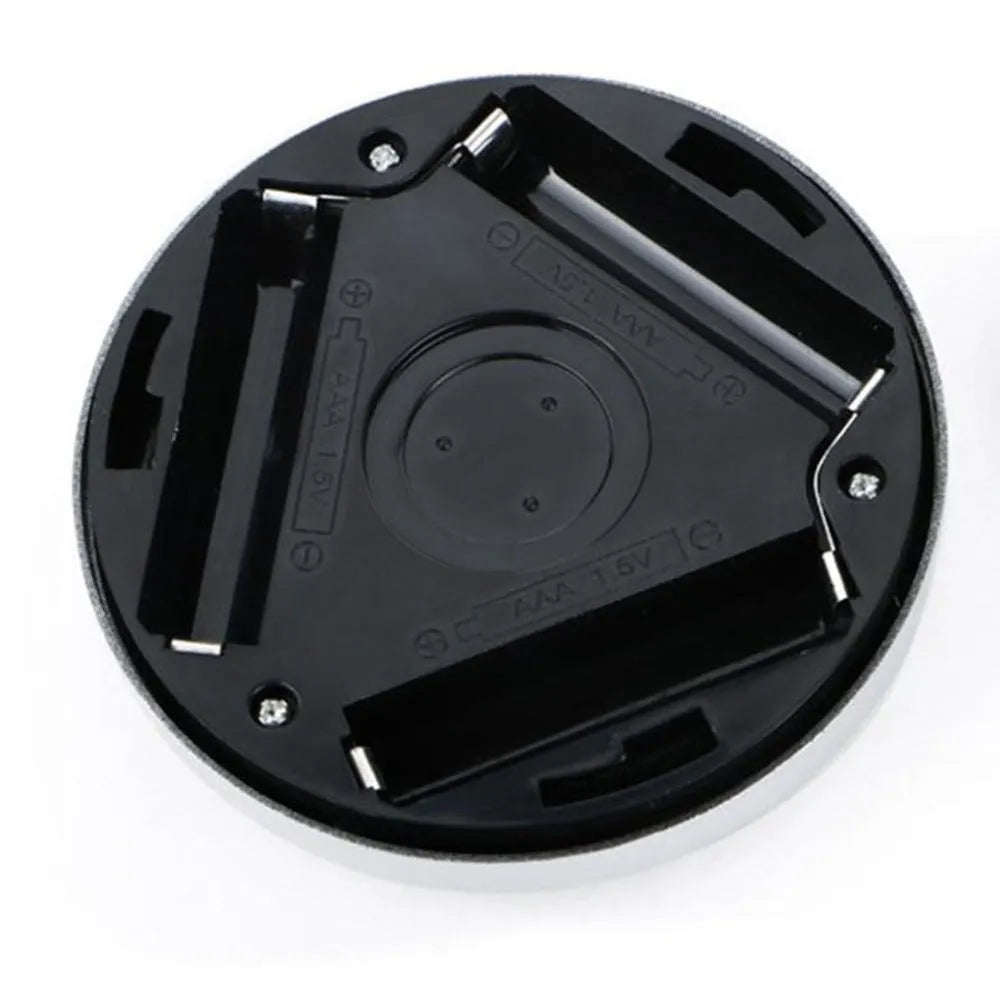 Silver wireless motion sensor night light with a square 80mm design on a table.