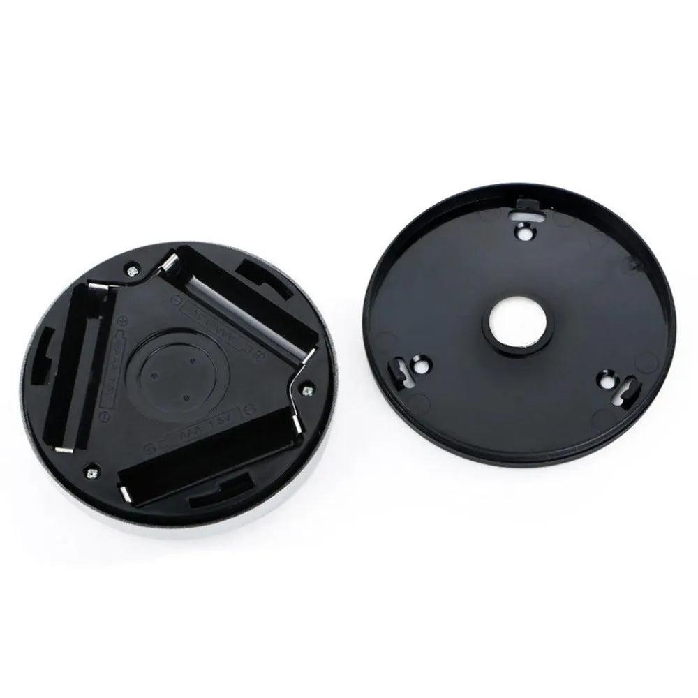 Silver wireless motion sensor night light with a square 80mm design on a table.