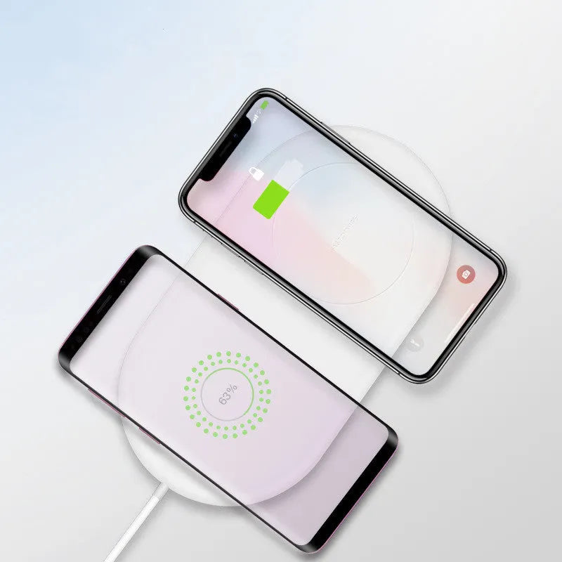 White dual mobile phone wireless charger showing two phones charging simultaneously