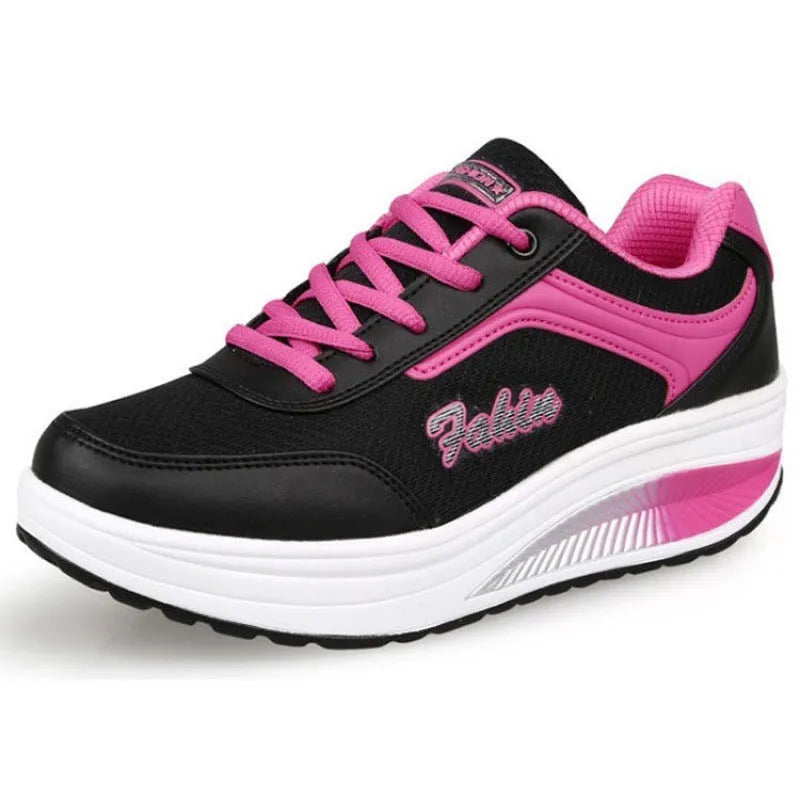 Women's grey pink mid-heel sports shoes with heelless sole design on a light background