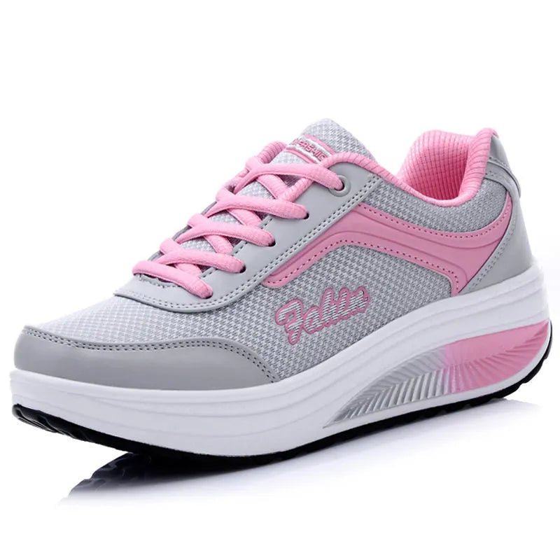 Women's grey pink mid-heel sports shoes with heelless sole design on a light background