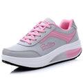 Women's grey pink mid-heel sports shoes with heelless sole design on a light background