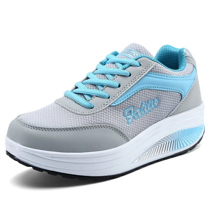 Women's grey pink mid-heel sports shoes with heelless sole design on a light background