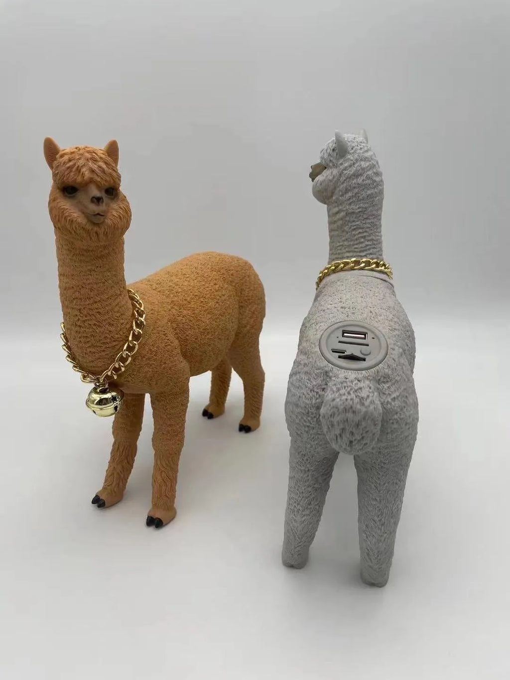 Portable Bluetooth speaker shaped like a brown alpaca with wood base, FM radio, and lanyard