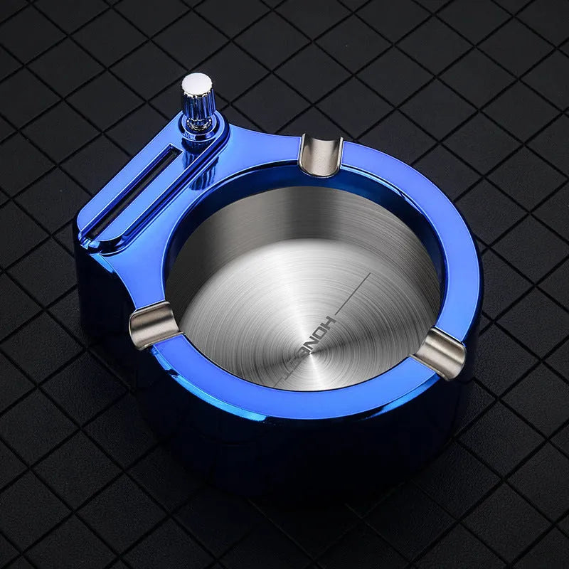 Large blue metal ashtray with a built-in permanent match lighter and three cigarette slots.