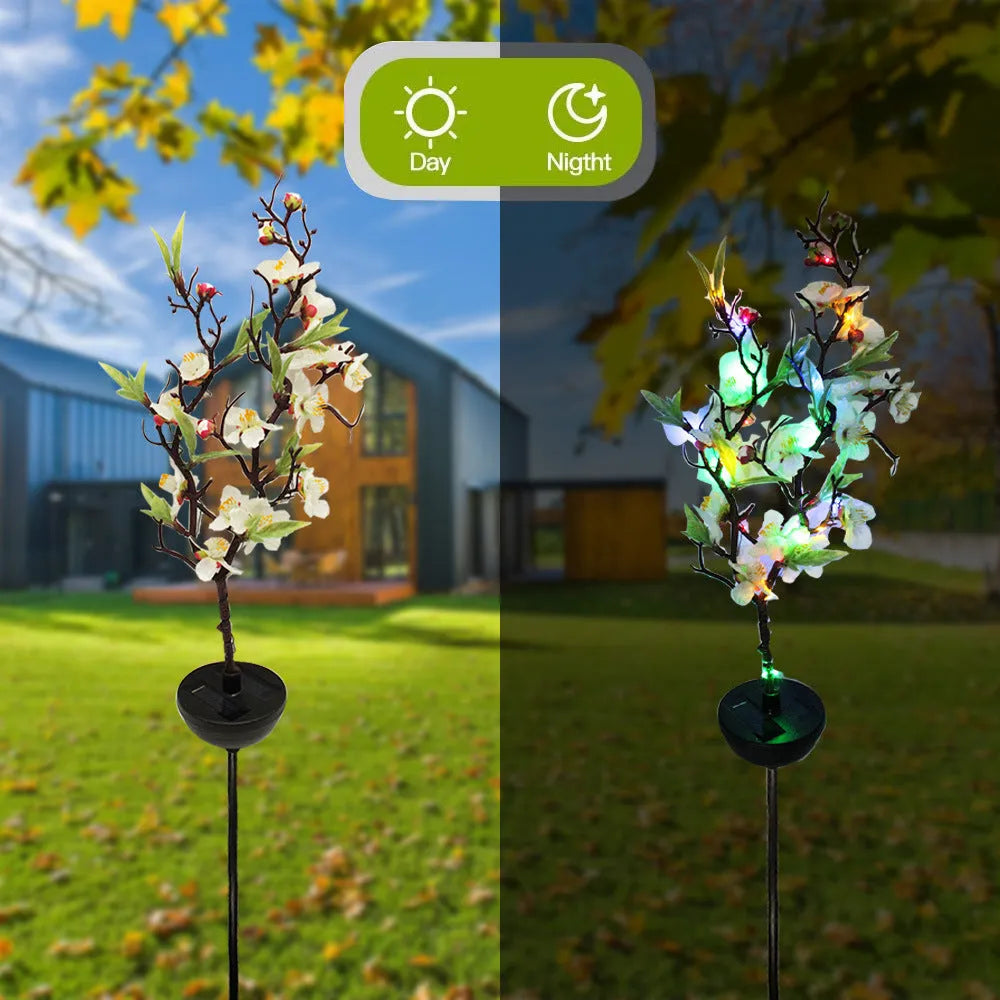 Solar-powered outdoor garden stake light with cherry blossom string LEDs and ground spike.