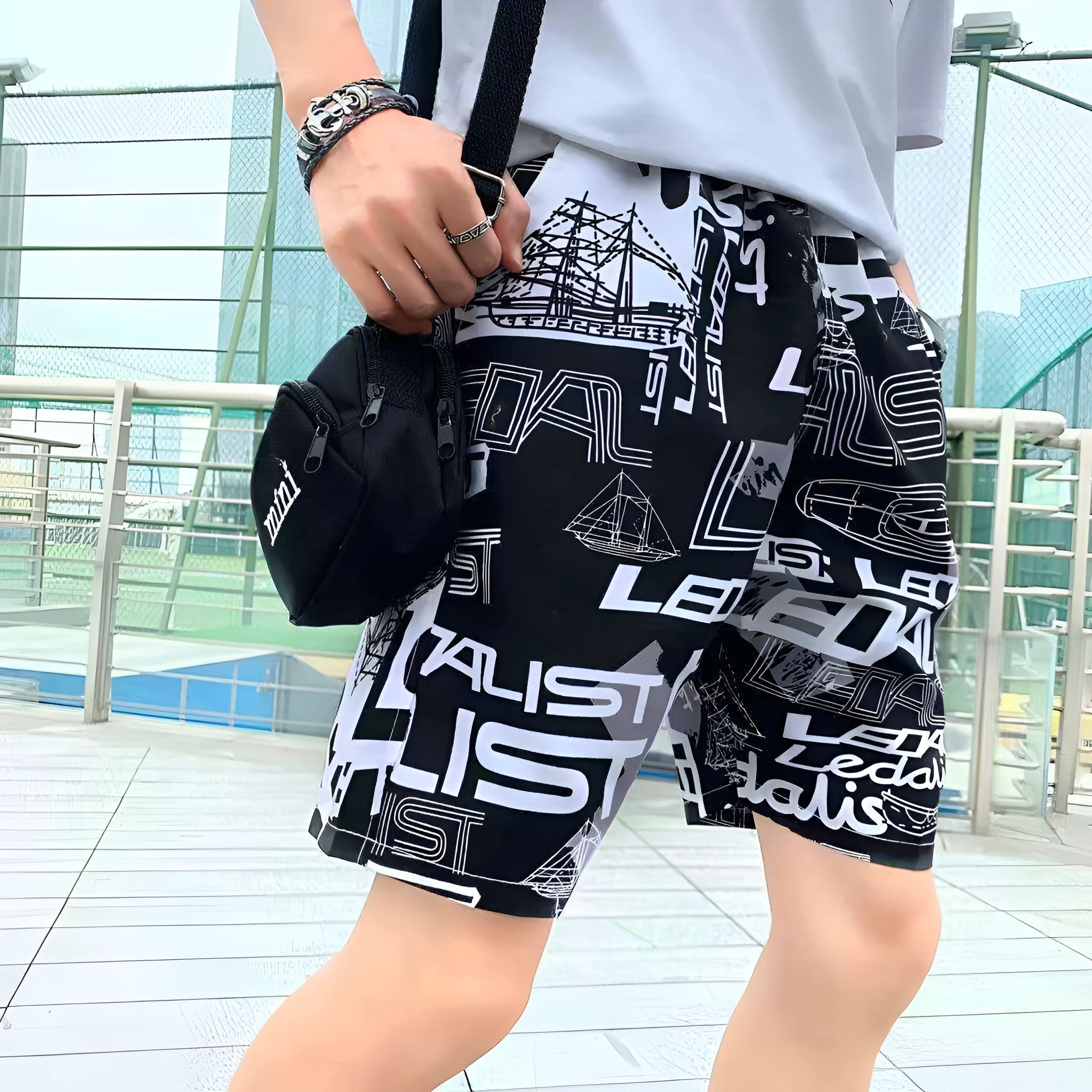 Men's loose five-point beach shorts in colourful feather print on thin cotton fabric
