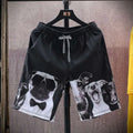 Men's loose five-point beach shorts in colourful feather print on thin cotton fabric