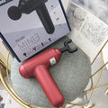 Handheld fascia gun massager in black, red, or white colour with USB charging port