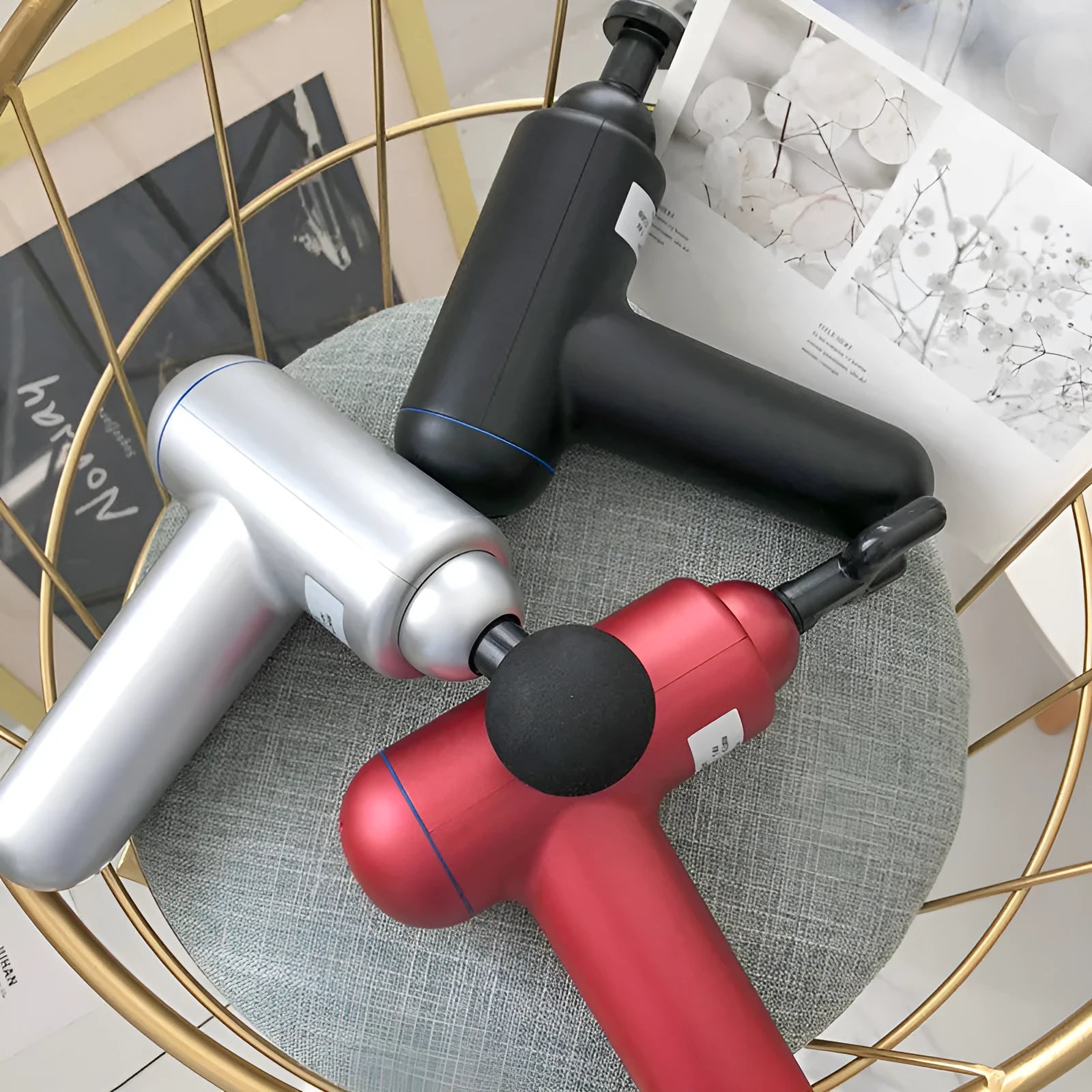 Handheld fascia gun massager in black, red, or white colour with USB charging port