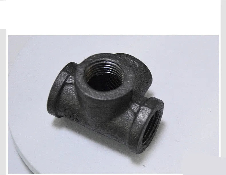 Malleable steel galvanized four-way corner pipe fitting in DN15 size on white background