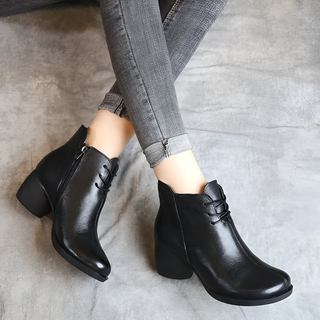 Women's brown leather Martin boots with a thick block heel and round toe.