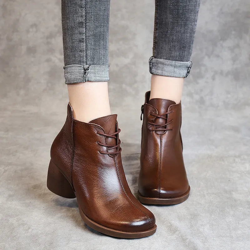 Women's brown leather Martin boots with a thick block heel and round toe.