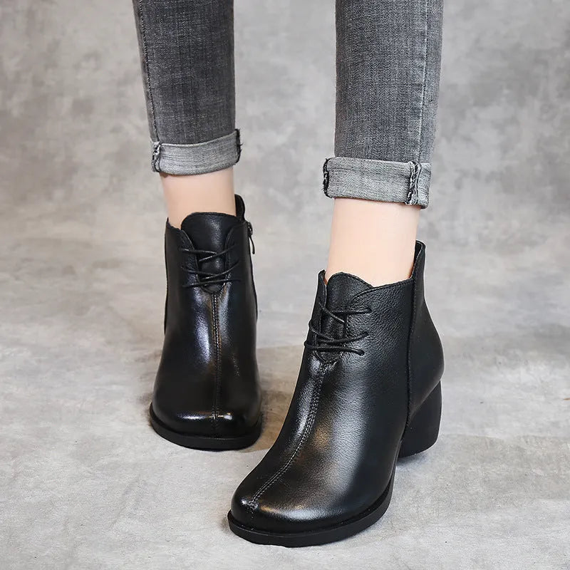 Women's brown leather Martin boots with a thick block heel and round toe.