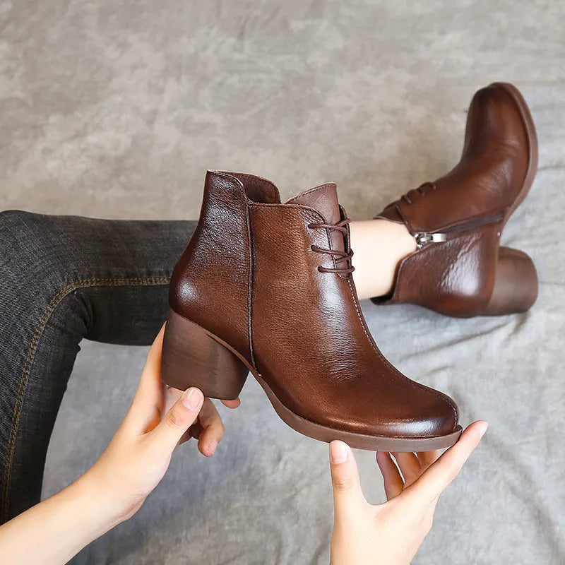 Women's brown leather Martin boots with a thick block heel and round toe.