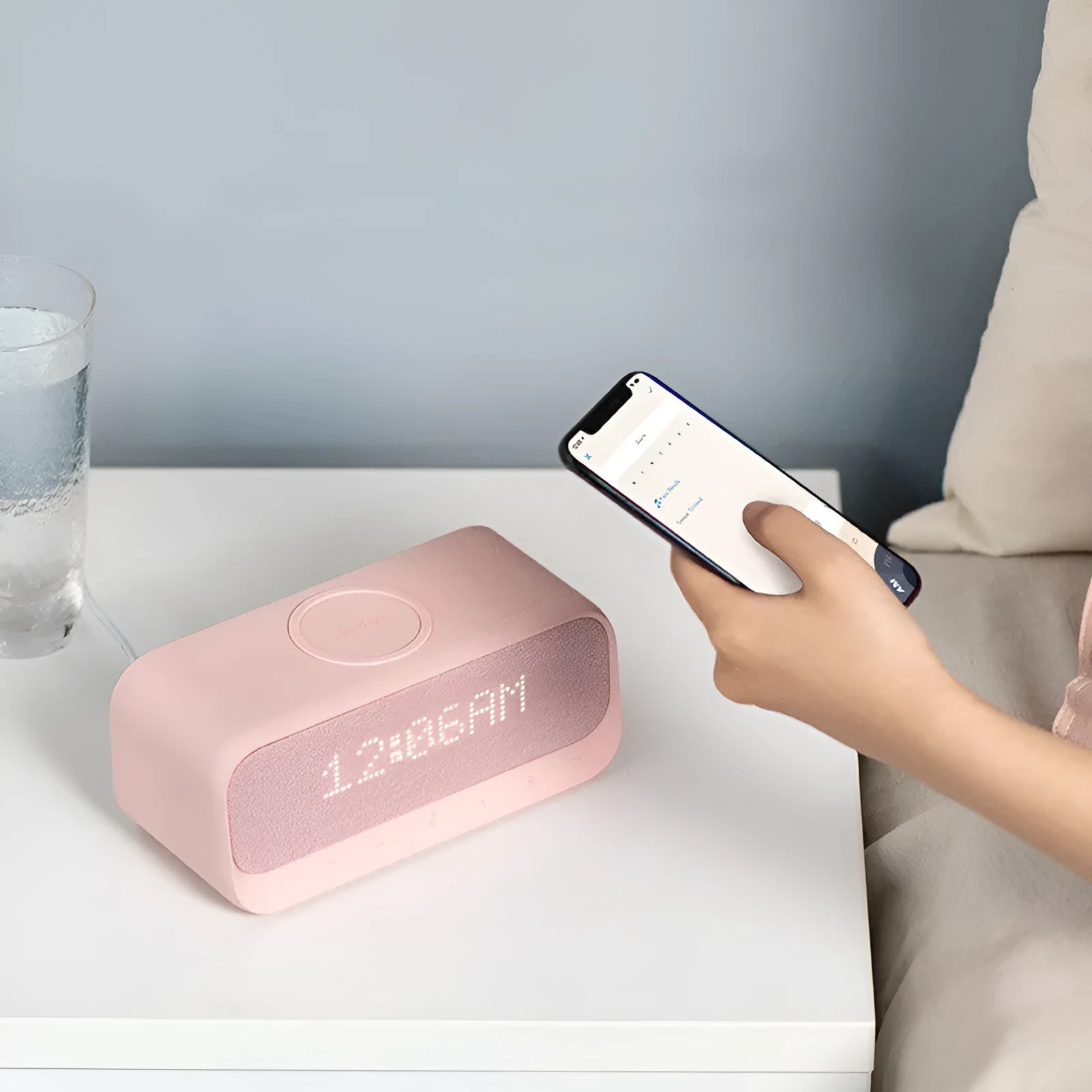 Anker Soundcore white or pink all-in-one Bluetooth speaker with wireless charging pad and digital display