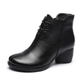 Women's brown leather Martin boots with a thick block heel and round toe.