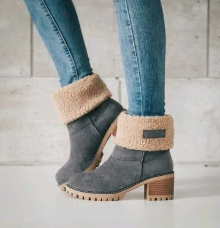 Women's black suede mid-tube snow boots with a thick heel and round toe on a waterproof platform sole.