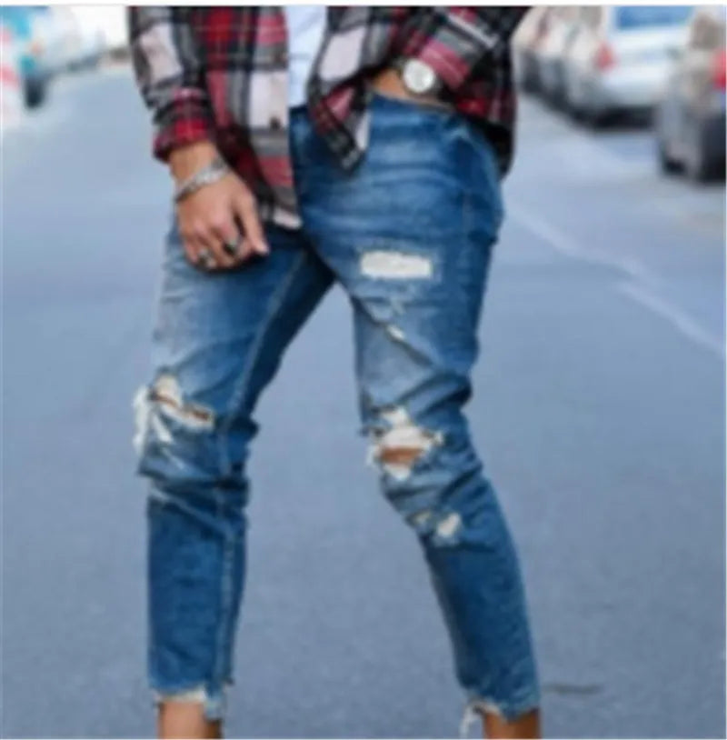 Deep blue men's jeans showing distressed hole details on the legs