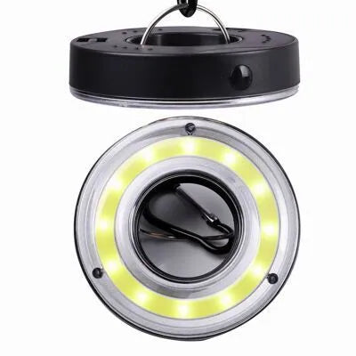 Primary colour COB LED tent light with carabiner hook and transparent lampshade on a dark background