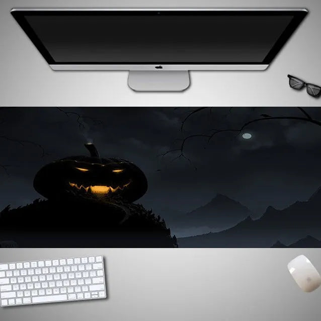 Oversized Halloween-themed computer mouse pad with non-slip rubber cloth backing on wooden desk