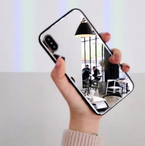 Black iPhone mirror case showing reflective surface on back, compatible with multiple iPhone models