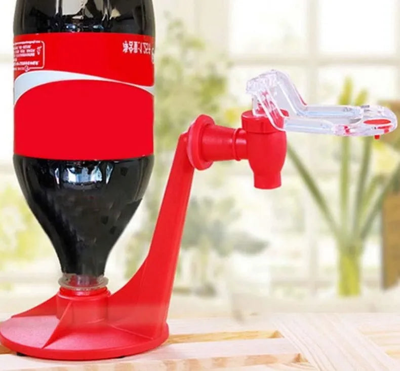 Red plastic Magic Tap soda drink dispenser for 2-litre bottles on a kitchen counter.