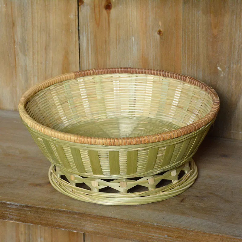 Handmade woven natural bamboo storage basket shown in a household setting.